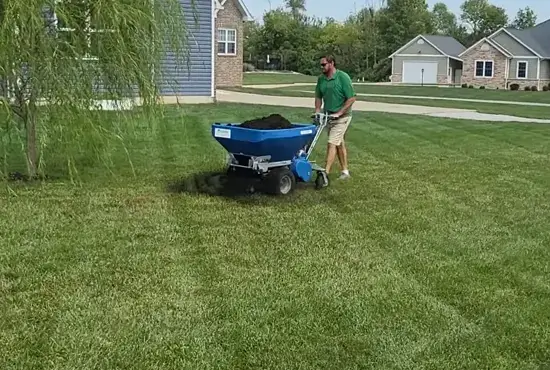 Lawn care technician applying soil treatment in New Baden, IL